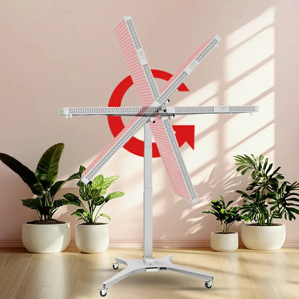360-degree rotating LED red light therapy panel on electric stand with green potted plants indoors
